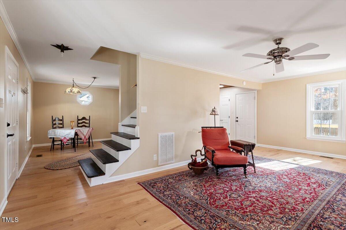 7120 Sandringham Drive Raleigh, NC 27613 - Photo 5 of 40 a living room with furniture and a rug