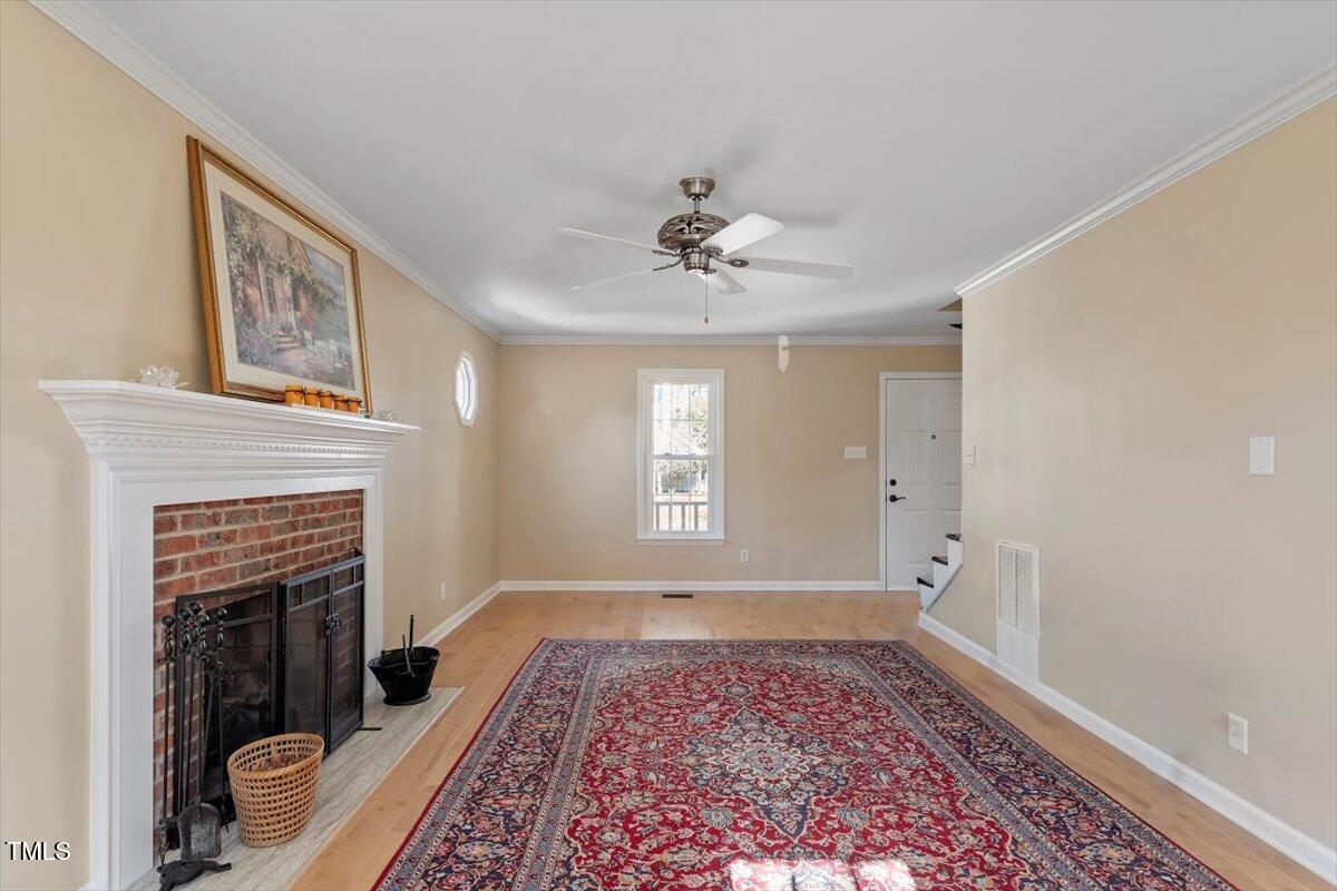 7120 Sandringham Drive Raleigh, NC 27613 - Photo 6 of 40 a view of an empty room with a fireplace