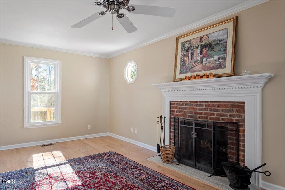 7120 Sandringham Drive Raleigh, NC 27613 - Photo 7 of 40 a living room with furniture and a fireplace