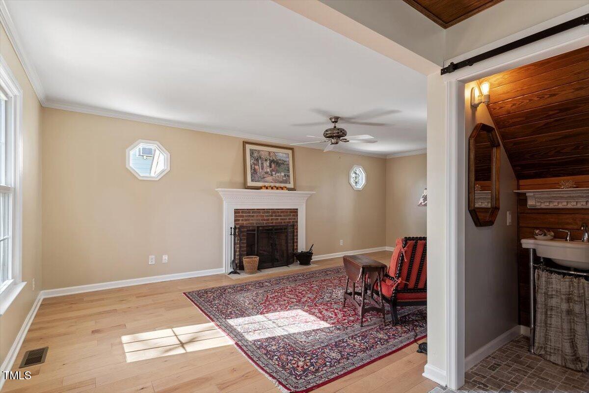 7120 Sandringham Drive Raleigh, NC 27613 - Photo 9 of 40 a living room with furniture and a fireplace