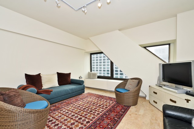 175 East Delaware Place, Unit 4619 Chicago, IL 60611 - Photo 3 of 10 a living room with furniture and a flat screen tv