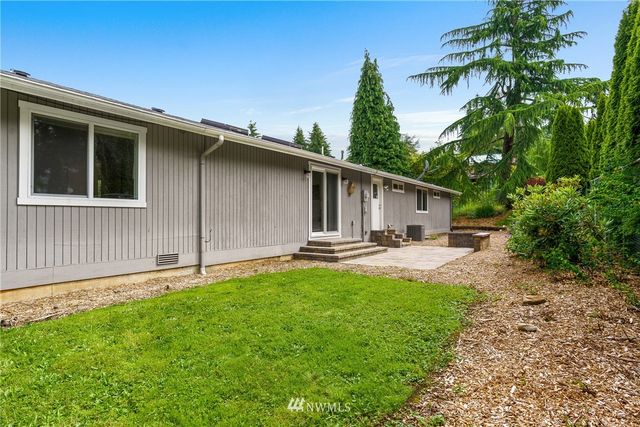 a front view of a house with yard patio and green space
