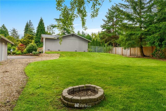a view of a backyard with a plants and trees