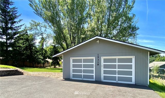 a view of a house with a yard and garage