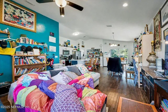 a living room with lots of furniture and kitchen view