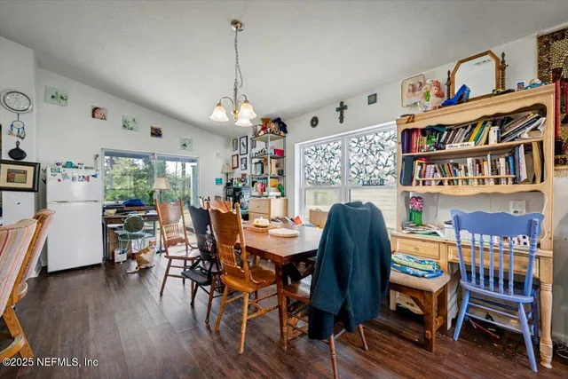 a dining room with furniture a rug and wooden floor