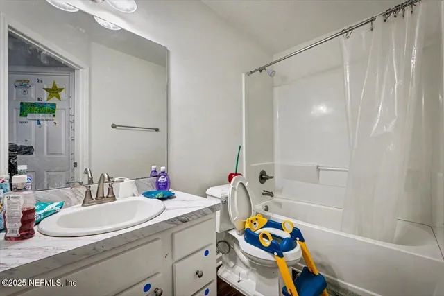 a bathroom with a sink mirror vanity and bathtub