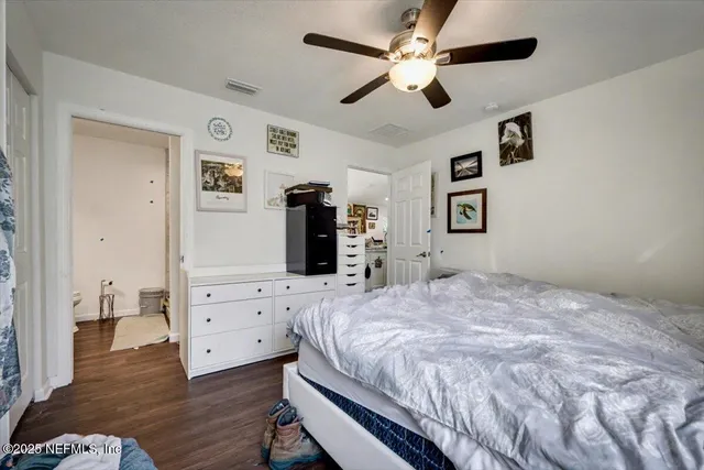 a bedroom with a bed chandelier and a closet