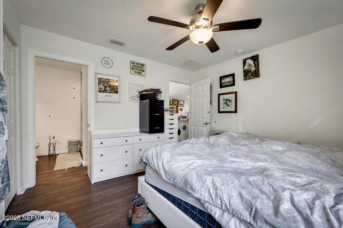 925 Scheidel Way St. Augustine, FL 32084 - Photo 9 of 10 a bedroom with a bed chandelier and a closet