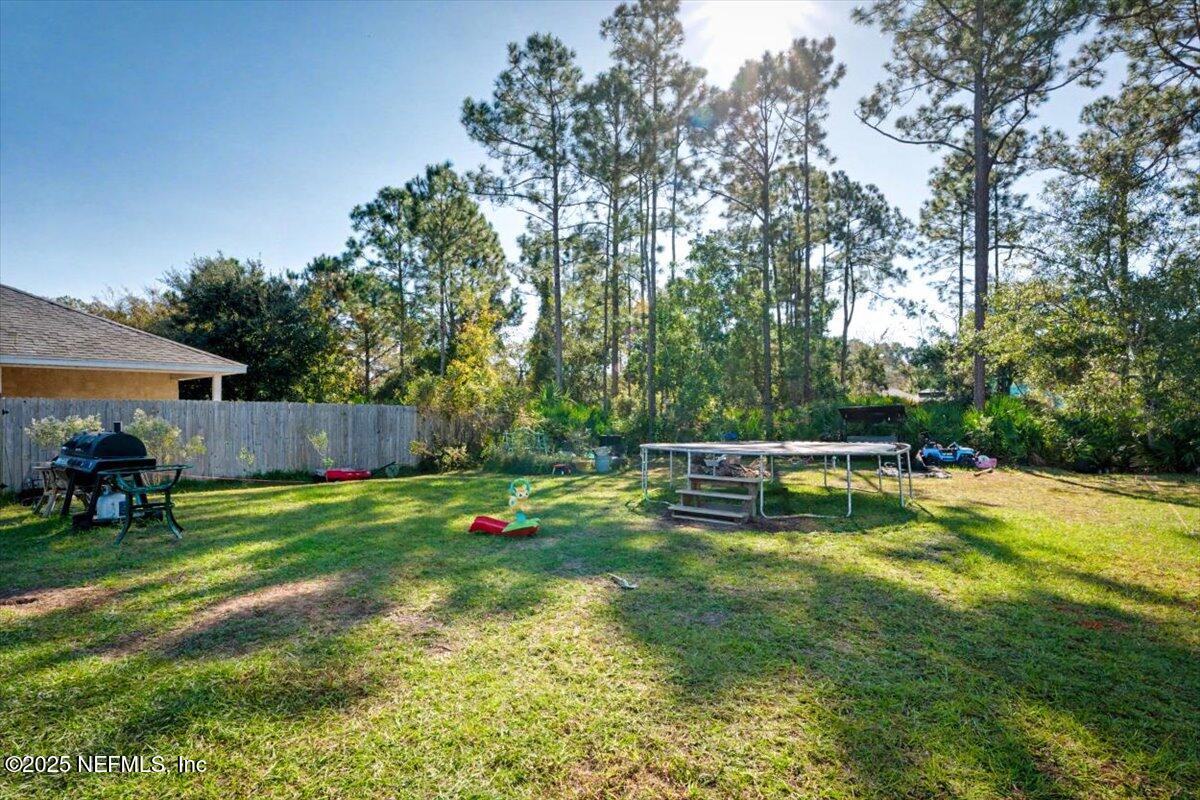 925 Scheidel Way St. Augustine, FL 32084 - Photo 10 of 10 a view of a swimming pool with lawn chairs and a big yard