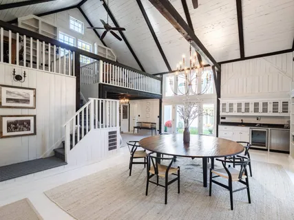 a dining room with furniture window and wooden floor