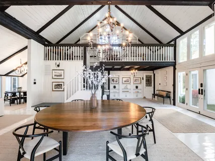 a dining room with furniture and a floor to ceiling window