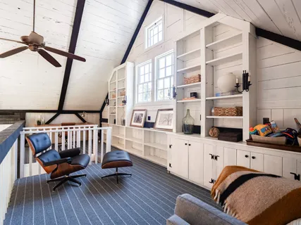 a bedroom with furniture and a window