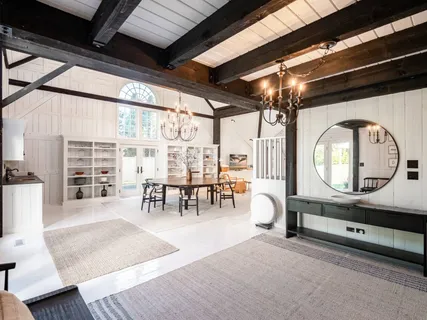 a spacious bedroom with a bed and a flat screen tv