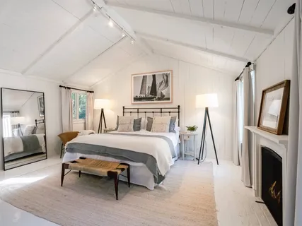 a spacious bedroom with a bed and a fireplace