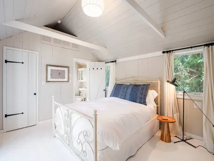 a bedroom with bed and window