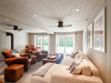 a living room with furniture a ceiling fan and a rug