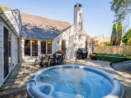 a backyard of a house with table and chairs