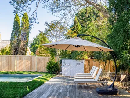 a view of a house with a yard and potted plants