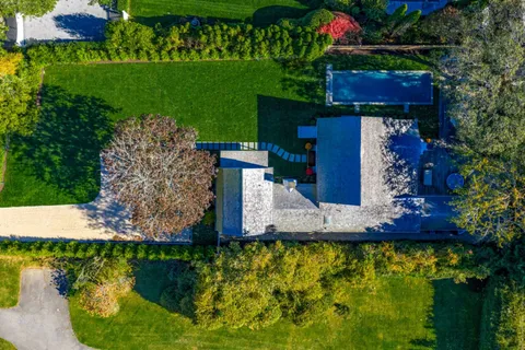 a front view of house with yard and swimming pool