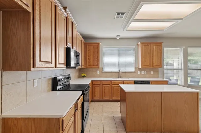 a kitchen with a sink stove and cabinets