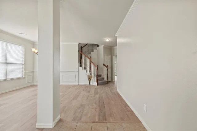 a view of a hallway with wooden floor and entryway