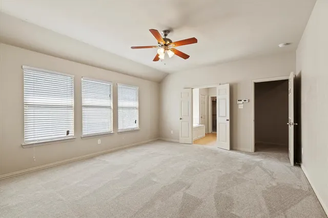 a view of a livingroom with a ceiling fan and window