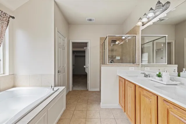 a bathroom with a tub sink and mirror