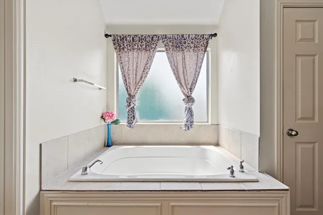 a bathroom with a bathtub and shower