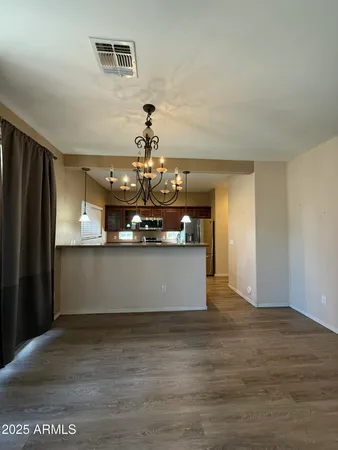 a large kitchen with stainless steel appliances granite countertop a lot of counter space and wooden floor