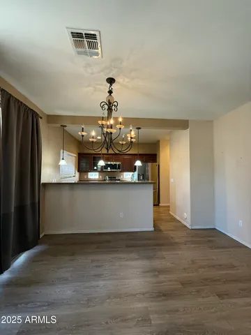 a large kitchen with stainless steel appliances granite countertop a lot of counter space and wooden floor