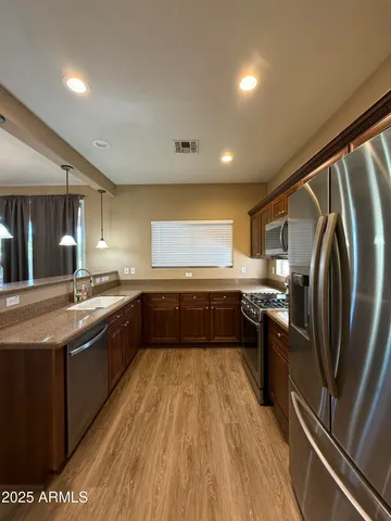 a stove top oven sitting inside of a kitchen