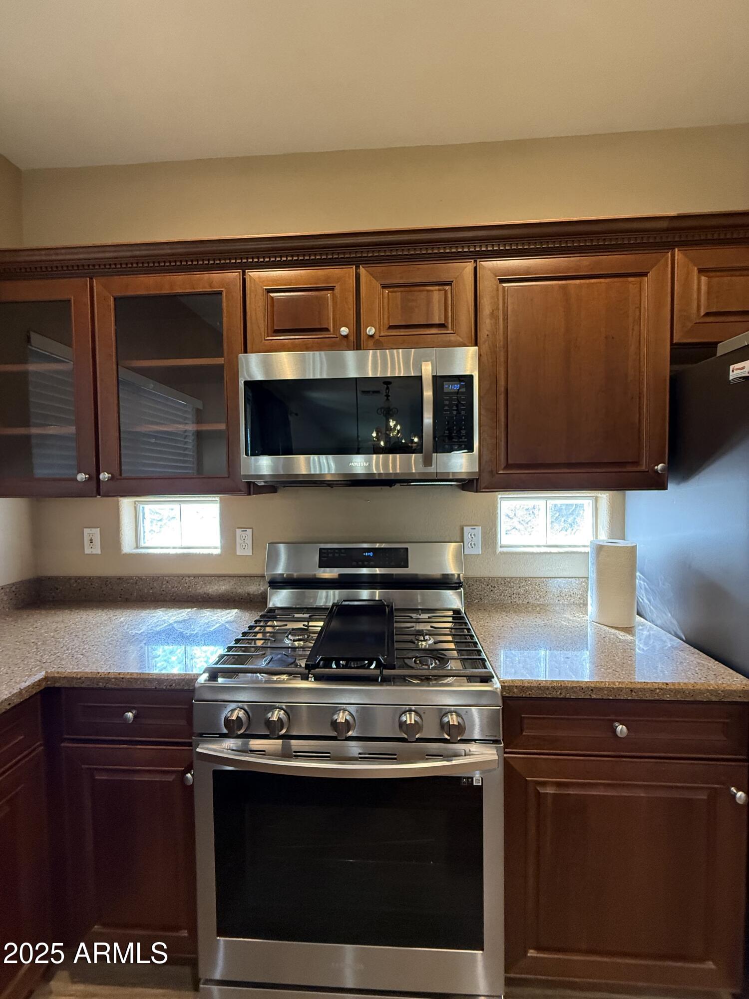 21975 East Vía Del Palo Queen Creek, AZ 85142 - Photo 6 of 19 a stove top oven sitting inside of a kitchen