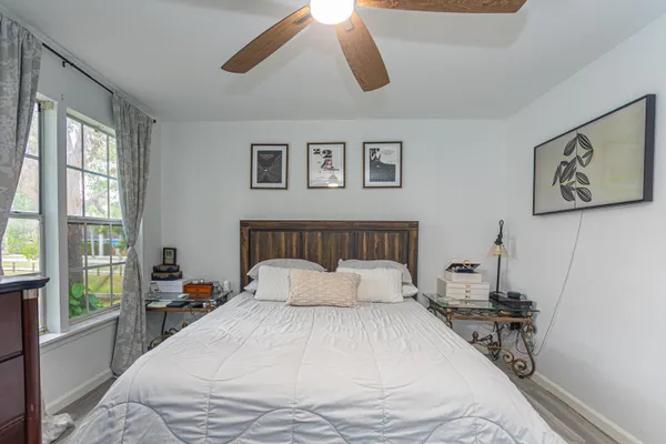 a bedroom with a large bed and a large window