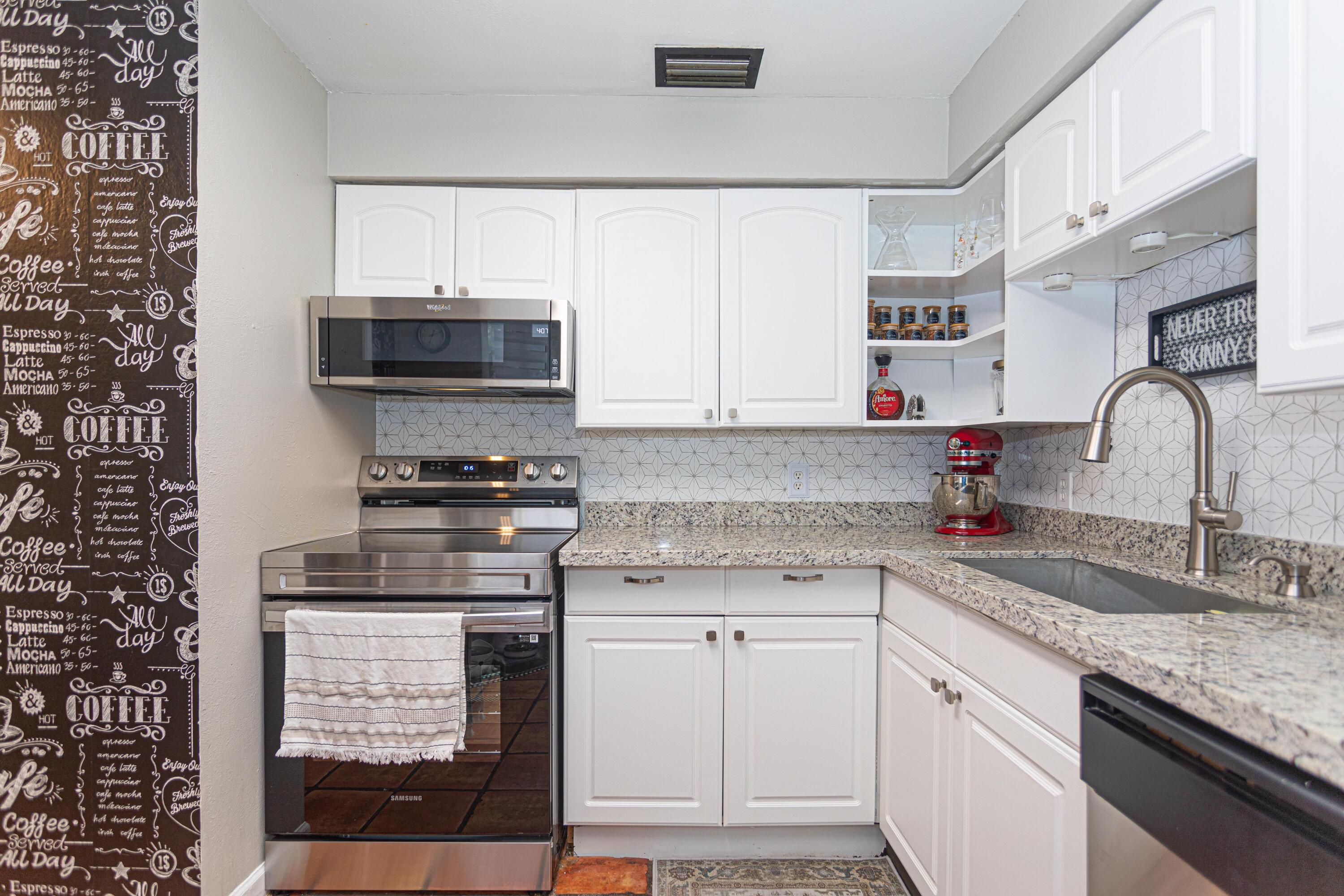 13460 Old Englishtown Road Wellington, FL 33414 - Photo 3 of 15 a kitchen with granite countertop a sink and cabinets