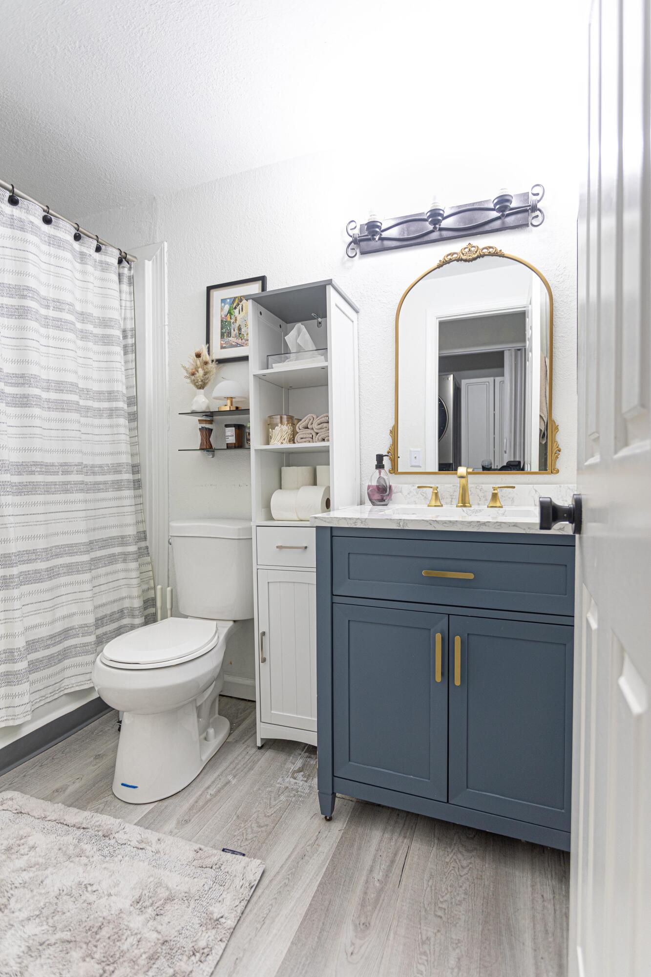 13460 Old Englishtown Road Wellington, FL 33414 - Photo 7 of 15 a bathroom with a toilet a sink and mirror