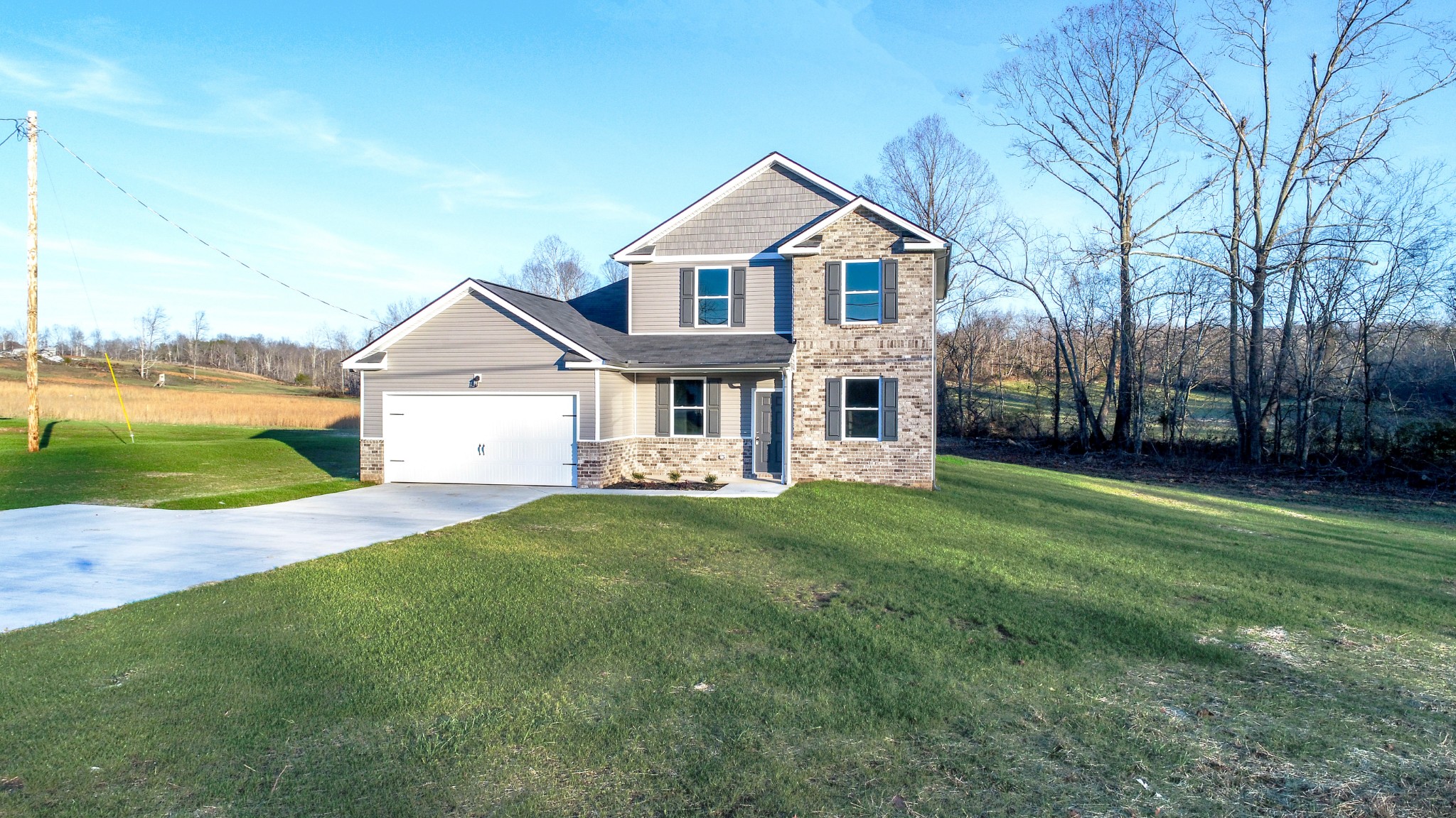 1063 East Piney Road Dickson, TN 37055 - Photo 1 of 22 a front view of a house with a yard and garage
