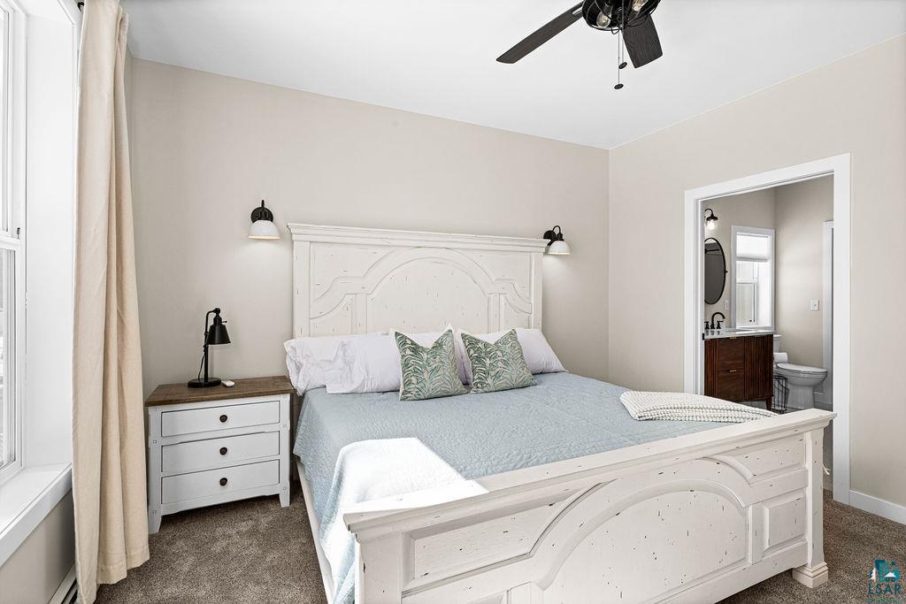 2236 Hoover Street Duluth, MN 55811 - Photo 15 of 52 Bedroom featuring dark carpet, connected bathroom, and ceiling fan