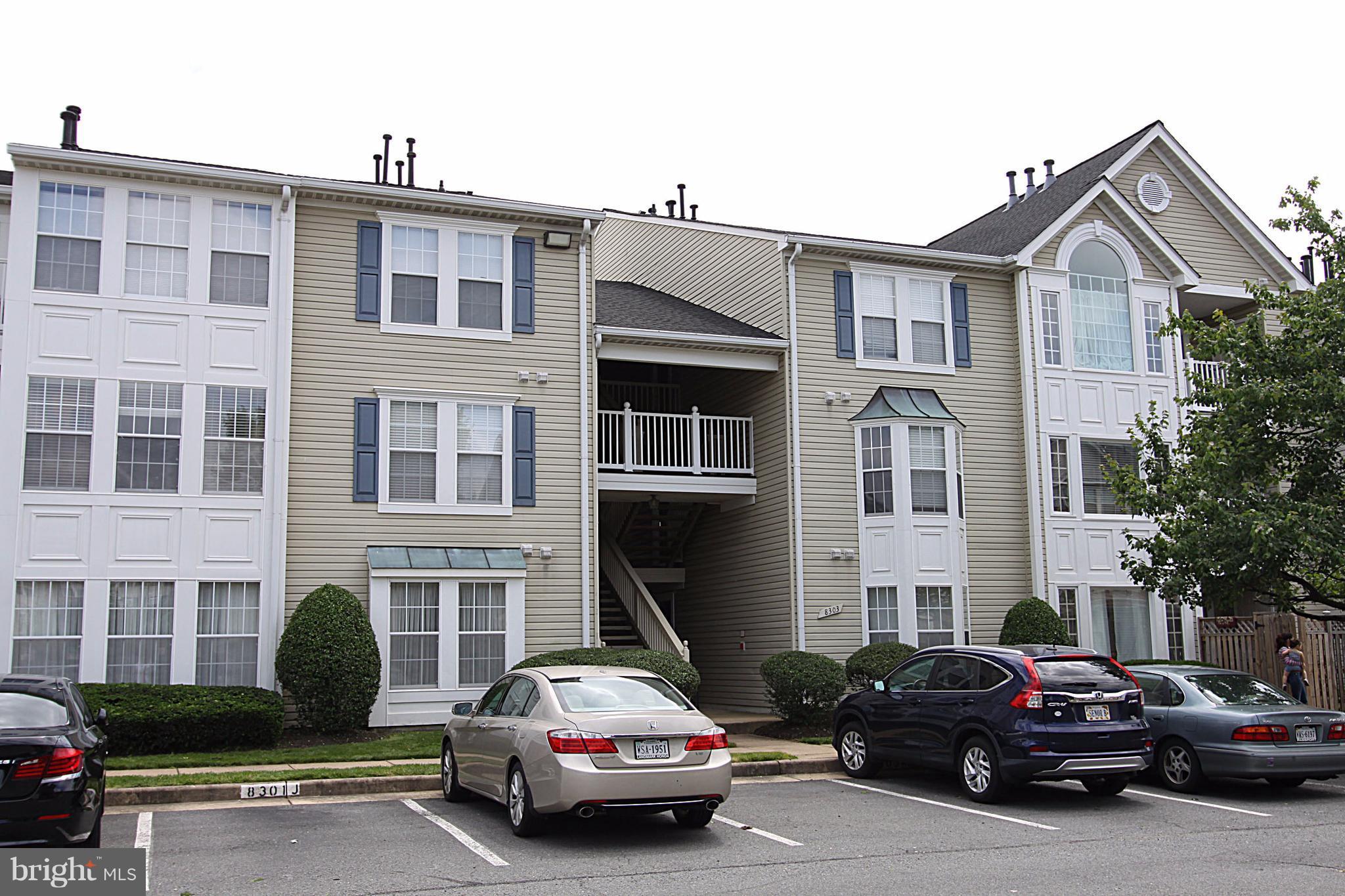 8303 Bluebird Way, Unit M Lorton, VA 22079 - Photo 1 of 9 a car parked in front of a brick house