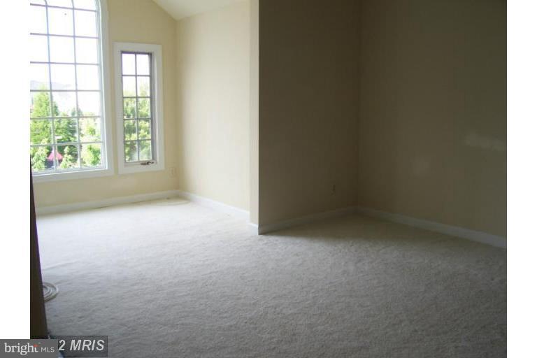8303 Bluebird Way, Unit M Lorton, VA 22079 - Photo 5 of 9 an empty room with windows
