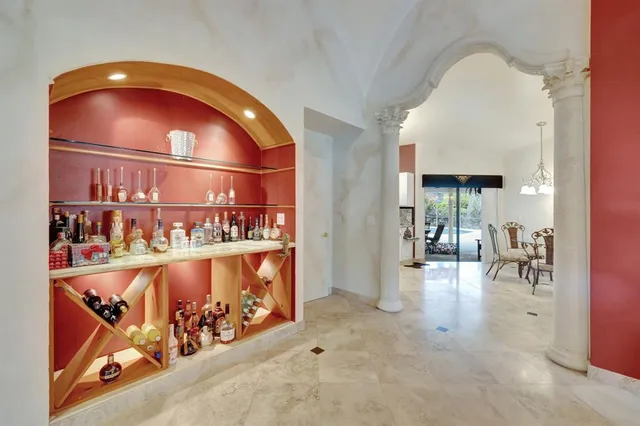 a large kitchen with granite countertop a sink stainless steel appliances and cabinets