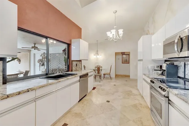 a view of a storage and utility room with two washing machine