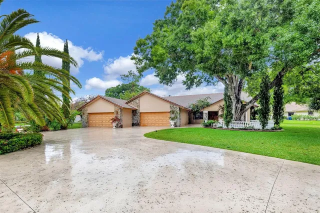 a front view of house with yard and green space