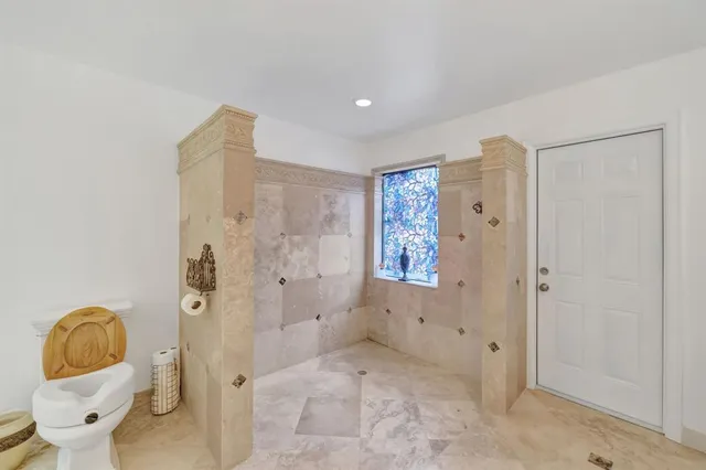 a bathroom with a sink a toilet and a mirror