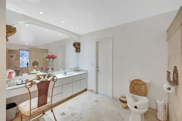 a spacious bathroom with a double vanity sink and a mirror