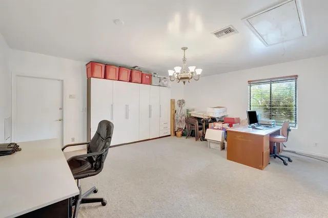 a dining room with furniture a chandelier and fireplace