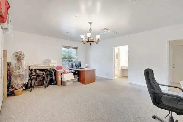 a view of a backyard with a table and chairs under an umbrella