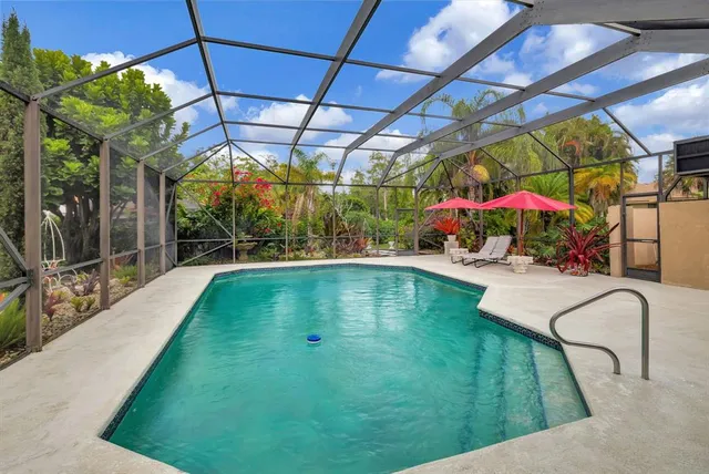 an aerial view of residential house with outdoor space and trees all around