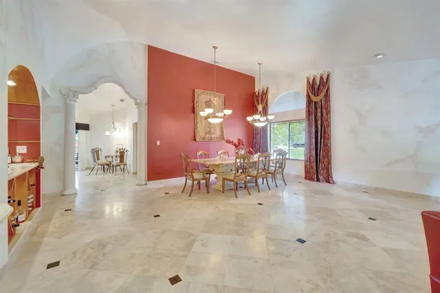 a living room with furniture a rug and a large window