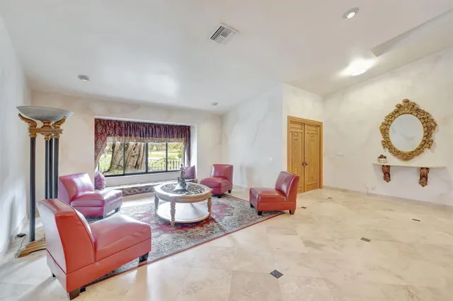 a view of a dining room with furniture and chandelier